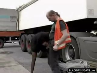 Black slattern riding on mature truck driver outside